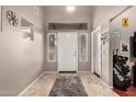 Bright foyer featuring tile flooring, a white front door, and decorative wall accents at 43303 N 44Th Ave, New River, AZ 85087