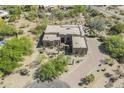 Expansive aerial view of an impressive desert-style home featuring mature trees and landscaping at 4772 E Agave Ln, Cave Creek, AZ 85331