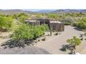 Aerial view of a desert-style home with well-maintained landscaping and brick driveway at 4772 E Agave Ln, Cave Creek, AZ 85331