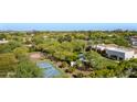 Expansive aerial view of the estate showcasing the pool, sport court, and mature tree coverage at 6648 E Horseshoe Rd, Paradise Valley, AZ 85253