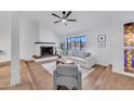 Inviting living room with a cozy fireplace, hardwood floors, and ample natural light at 753 W Pampa Ave, Mesa, AZ 85210