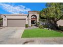 Charming home featuring an inviting gated entry, well-maintained lawn, and a convenient two-car garage at 7565 N Vía De La Siesta --, Scottsdale, AZ 85258