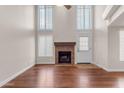 Living room with fireplace, hardwood floors, tall ceilings and bright, natural light with a door to the outside at 7835 E Glenrosa Ave # 13, Scottsdale, AZ 85251