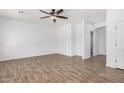 Spacious bedroom with wood-look floors, neutral paint, and a ceiling fan at 8037 W Mohave St, Phoenix, AZ 85043