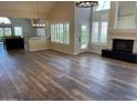 Open floor plan with lots of natural light, fireplace, and wood laminate flooring at 8136 E Cortez Dr, Scottsdale, AZ 85260