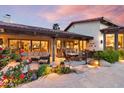 Inviting covered outdoor patio with comfortable seating, dining area, and beautiful garden views at 8514 E Country Club Trl, Scottsdale, AZ 85255