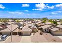 Beautiful neighborhood aerial view showcasing well-maintained homes with desert landscaping and tile roofs at 8657 E Capri Ave, Mesa, AZ 85208