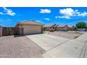 Street view of a single story home with a 2 car garage, neutral colored gravel yard and light colored driveway at 8657 E Capri Ave, Mesa, AZ 85208