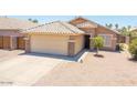 Charming single-story home featuring a well-maintained yard, two-car garage, and neutral color palette at 8657 E Capri Ave, Mesa, AZ 85208