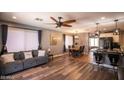 Cozy living room with stylish furnishings and hardwood-style flooring, flowing into the kitchen at 8657 E Capri Ave, Mesa, AZ 85208
