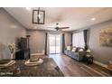 Inviting living room with natural light, modern ceiling fan, and easy access to outdoor living at 8657 E Capri Ave, Mesa, AZ 85208