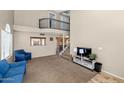 Spacious living room featuring a loft, carpeted floors, and a view of the kitchen at 9026 W Cambridge Ave, Phoenix, AZ 85037