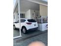 Car parked at attractive single-story home featuring a small porch and carport at 1001 S Prospector Dr # 1001, Apache Junction, AZ 85119