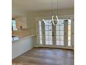 Contemporary dining area with modern chandelier and access to the outdoors through French doors at 1301 N 44Th St, Phoenix, AZ 85008