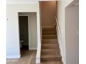 Wood staircase leads upstairs with a view into the downstairs bathroom at 1301 N 44Th St, Phoenix, AZ 85008