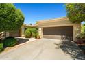 A single-story home with well-maintained landscaping, a neutral color palette, and a tile roof at 13134 W Los Bancos Ct, Sun City West, AZ 85375