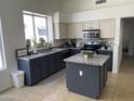 Bright kitchen with granite countertops, stainless steel appliances, a center island, and a window at 1314 S Larkspur St, Gilbert, AZ 85296