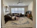 Spacious living room featuring vaulted ceilings, a comfortable L-shaped couch, and a decorative area rug at 1314 S Larkspur St, Gilbert, AZ 85296