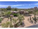 Beautiful desert home boasts manicured landscaping, adding to the property's curb appeal at 1401 E Boulder Pass Pass, Carefree, AZ 85377
