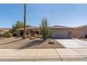Charming home with desert landscaping, tile roof, and a spacious two-car garage at 15797 W Cinnabar Dr, Surprise, AZ 85374