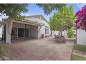 Private backyard featuring a covered patio, tile flooring, and lush greenery, ideal for outdoor entertaining at 16235 W Cottonwood St, Surprise, AZ 85374