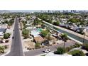 Expansive aerial view of a residential neighborhood with a canal and downtown skyline at 1644 W Roma Ave, Phoenix, AZ 85013