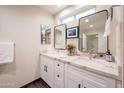 Bright bathroom features double vanity with modern fixtures, granite counters and updated lighting at 1644 W Roma Ave, Phoenix, AZ 85013