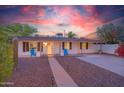 Charming single-story home featuring manicured front yard, walkway, and colorful sky at dusk at 1644 W Roma Ave, Phoenix, AZ 85015