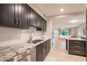 Modern kitchen featuring gray cabinetry, stainless steel appliances, and white backsplash at 1644 W Roma Ave, Phoenix, AZ 85015