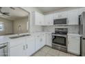 Modern kitchen featuring stainless steel appliances, white cabinetry, and light countertops at 17953 N Lettere Cir, Maricopa, AZ 85138