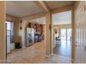 View of the entryway, living spaces, and kitchen with tile flooring in an open concept layout at 18586 N Lariat Rd, Maricopa, AZ 85138
