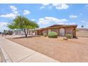 Charming home featuring arched windows, desert landscaping, and a covered carport at 1902 E 8Th St, Mesa, AZ 85203