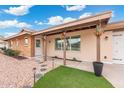 Inviting front entrance with hanging flower baskets, a brick walkway, and a well-maintained garden at 1985 W Anderson Ave, Phoenix, AZ 85023