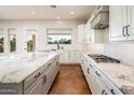 Bright kitchen with white cabinets, granite countertops, tile floor, and stainless steel appliances at 22208 N San Ramon Dr, Sun City West, AZ 85375