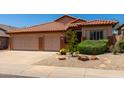 Charming home featuring a tile roof, gravel landscaping, and a spacious three-car garage at 22232 N 48Th St, Phoenix, AZ 85054