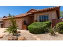 Beautiful home with a tile roof, desert landscaping, and a covered entryway at 22232 N 48Th St, Phoenix, AZ 85054