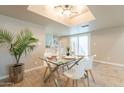 Bright dining area featuring modern lighting, a glass table, and backyard access at 2320 S Forest Ave, Tempe, AZ 85282