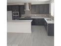 Modern kitchen featuring stainless steel appliances, dark cabinetry, and a white center island at 2463 W Rowel Rd, Phoenix, AZ 85085