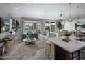 Bright living room featuring stylish decor, large windows, and open floor plan at 2486 W Rowel Rd, Phoenix, AZ 85085