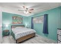 Cozy bedroom with a ceiling fan, wood-style flooring, and soft decor at 2700 E Allred Ave # R87, Mesa, AZ 85204