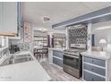 Well-lit kitchen with stainless steel appliances, adjacent dining area, and modern finishes at 2700 E Allred Ave # R87, Mesa, AZ 85204