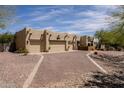 Exterior elevation showcases the home's three car garage and desert landscaping at 37809 N 9Th Pl, Phoenix, AZ 85086
