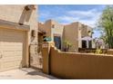 Exterior view of the home's gated entry and front courtyard with desert landscaping at 37809 N 9Th Pl, Phoenix, AZ 85086