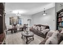 Elegant living room with stylish furnishings, a decorative chandelier, and wood-look tile floors at 4232 S 103Rd Ln, Tolleson, AZ 85353