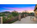 Enjoy mountain views from this spacious balcony with neutral toned posts and decorative wrought iron at 5231 W Desperado Way, Phoenix, AZ 85083