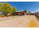 Desert home with a spacious driveway and minimalist landscaping at 525 N 94Th Way, Mesa, AZ 85207