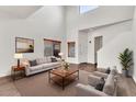 Bright living room with high ceilings, neutral decor, wood blinds, and modern furnishings, perfect for entertaining at 544 N Alma School Rd # 28, Mesa, AZ 85201
