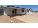 Single-story home featuring a concrete driveway and covered parking at 632 N 95Th St, Mesa, AZ 85207