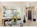 Inviting entryway with views of a modern kitchen featuring stainless steel appliances and a breakfast bar at 6579 E Shooting Star Way, Scottsdale, AZ 85266