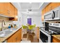 Bright kitchen featuring stainless steel appliances, granite countertops, and wood flooring at 7350 N Via Paseo Del Sur -- # O202, Scottsdale, AZ 85258